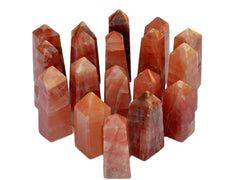 Several rose calcite crystal towers on white background