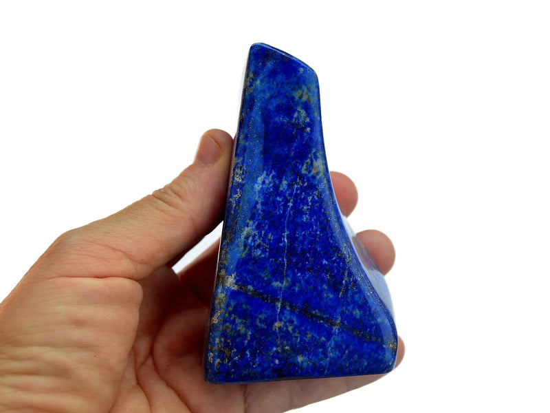 Two lapis lazuli free form slab crystals 100mm on hand with white background