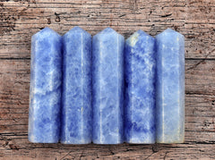 Five blue calcite obelisk towers 90mm on wood background