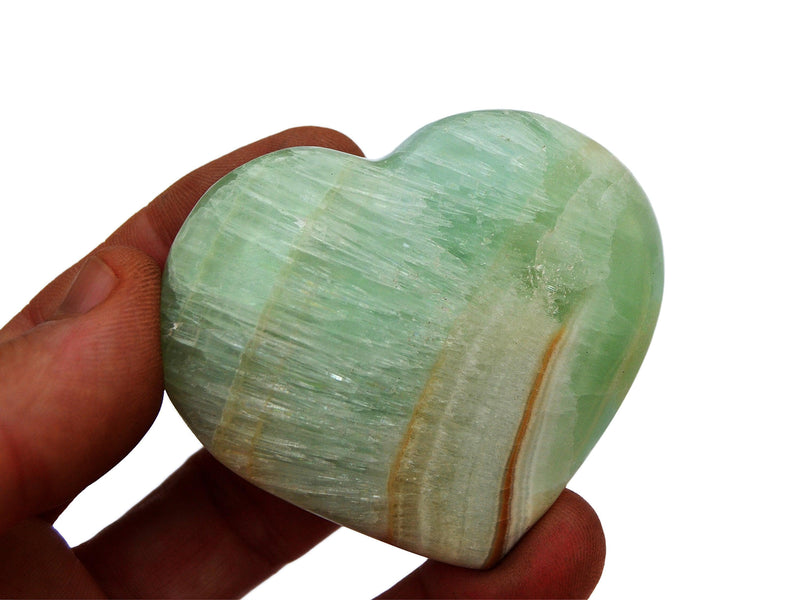 One green banded pistachio calcite hart mineral 55mm on hand with white background