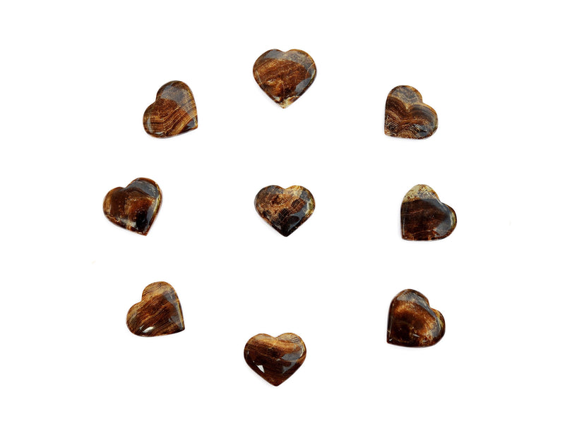 Some chocolate calcite heart minerals 30mm-35mm forming a circle on white background