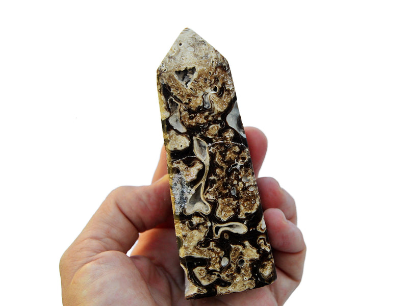 One natural druzy chocolate calcite 100mm on hand with white background
