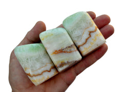 Three aqua caribbean calcite free form crystals on hand with white background