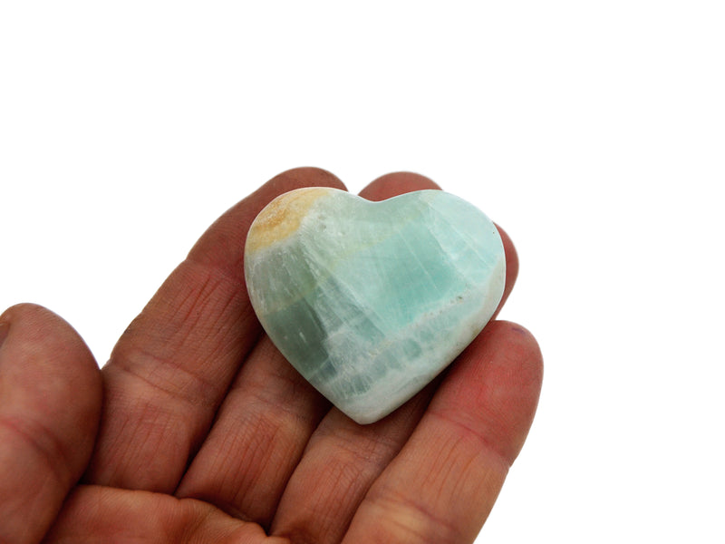 One  blue caribbean calcite small heart 35mm on hand with white background