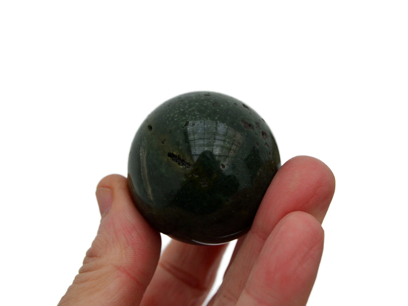 One gree ocean jasper sphere 40mm on hand with white background