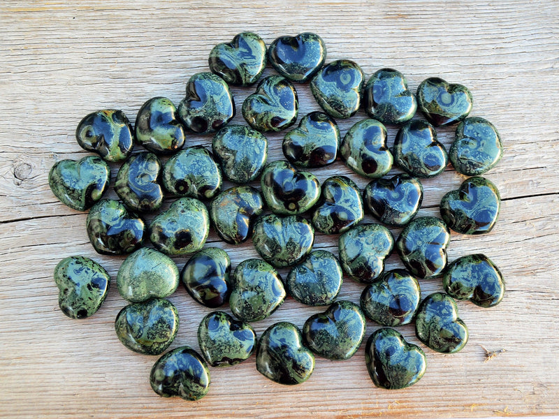 Several kambaba jasper heart shapped minerals 30mm on wood table