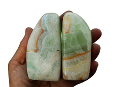 Two large green caribbean calcite slabs on hand with white background 