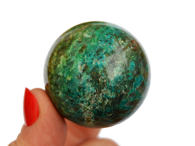 Green chrysocolla sphere crystal 40mm on hand with white background
