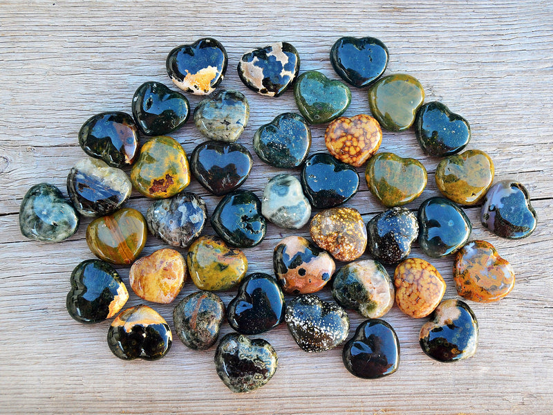 Seveal sea jasper shapped heart stones 30mm on wood table