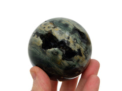 One druzy ocean jasper crystal sphere 60mm on hand with white background