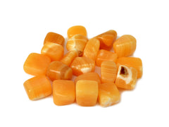 Some orange calcite mini tumbled crystals on white background