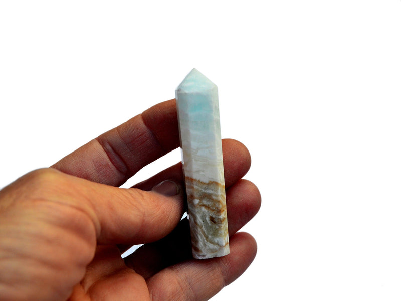 One blue calcite caribbean calcite point crystals 60mm on hand with white background