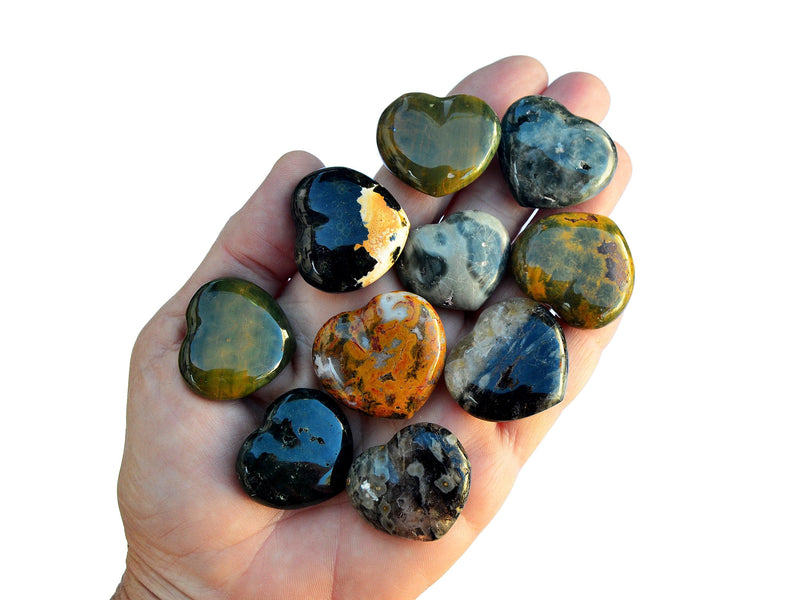 Ten ocean jasper crystal hearts 30mm o n hand with white background