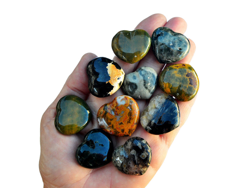 Ten ocean jasper heart shapped crystals 30mm on hand with white background