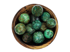 Several green chrysocolla crystal spheres 25mm - 40mm inside a wood bowl on white background