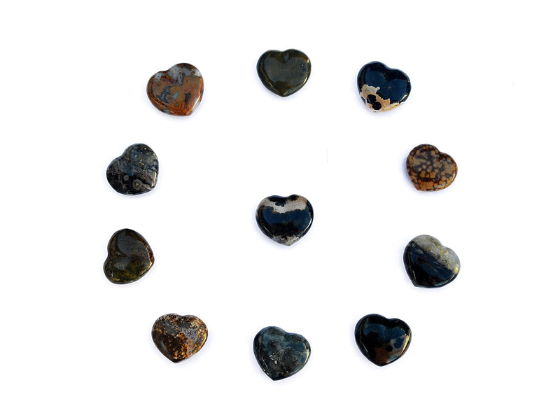Several ocean jasper crystal hearts 30mm forming a circle on white background