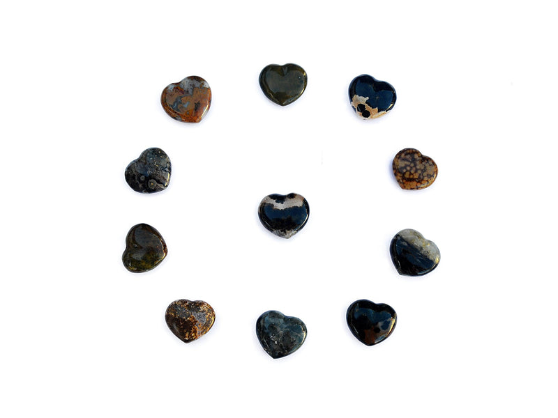 Several ocean jasper heart crystals 30mm forming a circle on white background