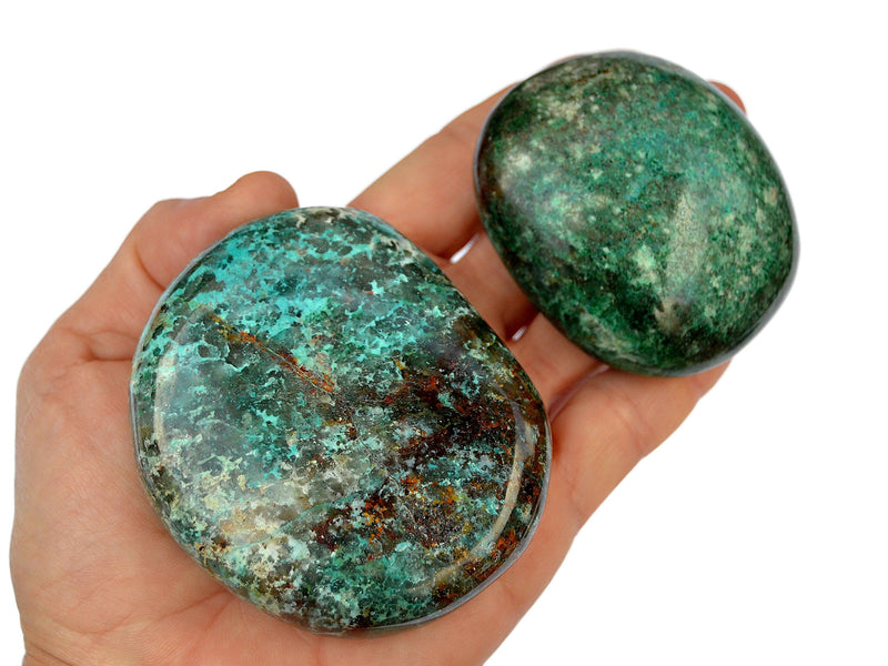 Two chrysocolla palm stones 50mm-70mm on hand with white background