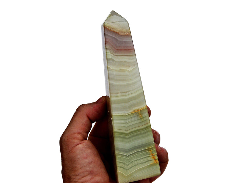 One large pink banded onyx crystal tower 150mm on hand with white background