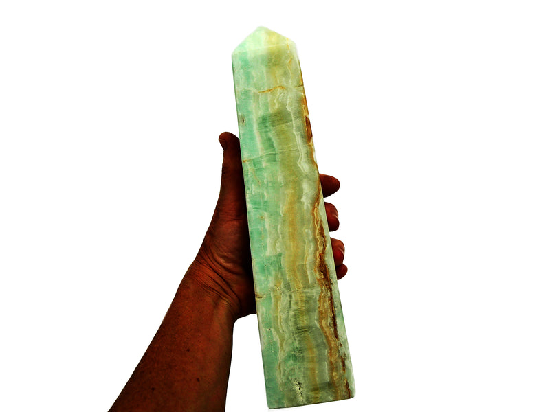 One extra large blue caribbean calcite obelisk crystal 270mm on hand with white background