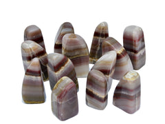 Some pink banded onyx free form minerals 60mm-110mm on white background