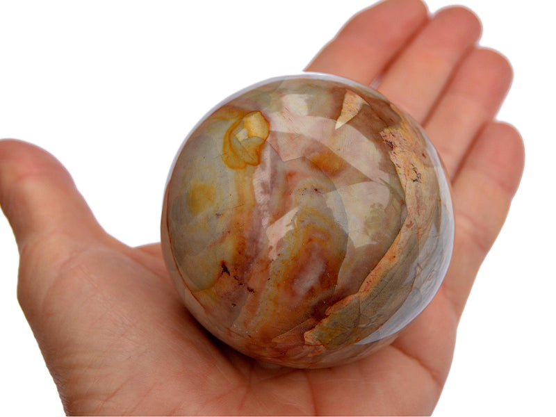 One desert jasper crystal ball 55mm on hand with white background