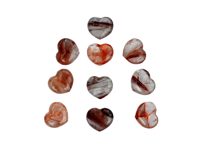 Some fire quartz puffy heart crystals 30mm on white background