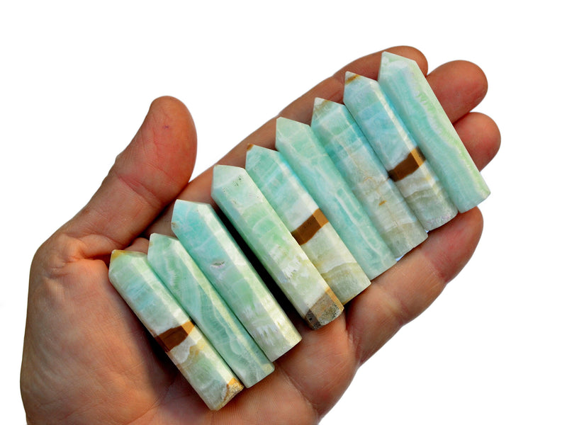 Nine blue caribbean calcite crystal points 45mm-60mm on hand with white background
