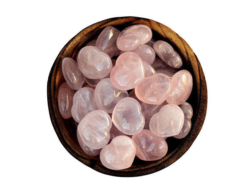 Several rose quartz heart shapped crystals 30mm inside a wood bowl on white background