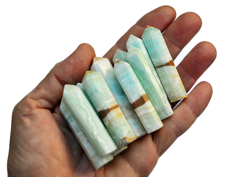 Some blue caribbean calcite points 45mm-60mm on hand with white background