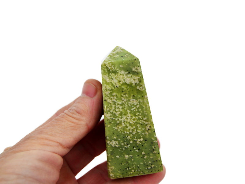 One green serpentine obelisk crystal 60mm on hand with white background