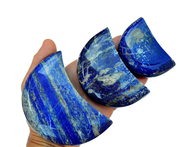 hree lapis lazuli moon carving stones 65mm-90mm on hand with white background
