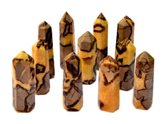 Several yellow septarian faceted points 90mm-140mm on white background