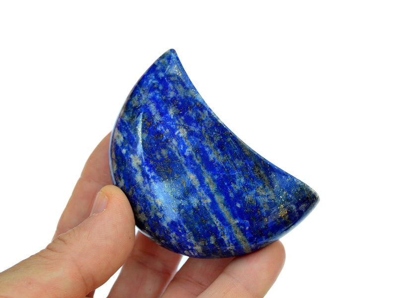 One large blue lapis lazuli crystal moon 65mm on hand with white background 