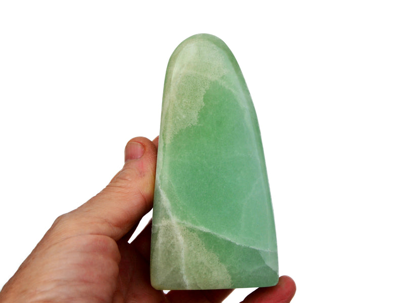 One large pistachio calcite free form crystal 100mm on hand with white background