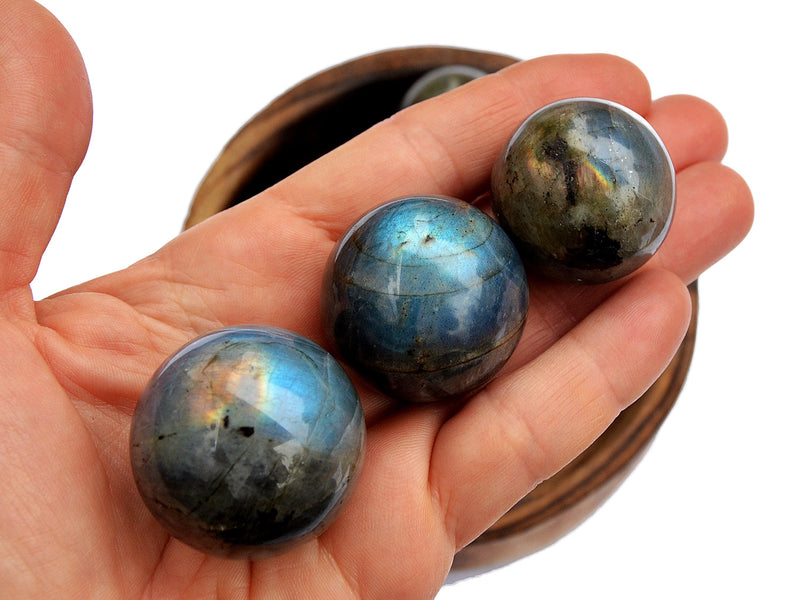 Three labradorite spheres 25mm-30mm on hand 