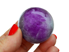 One purple amethyst sphere 40mm on hand with white background