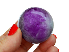 One amethyst sphere 40mm on hand with white background