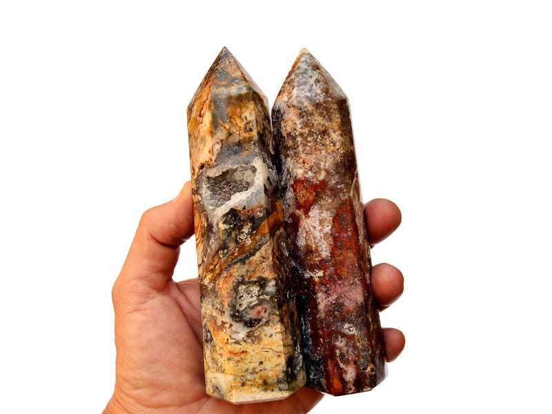 Two multicolor ocean jasper crystal points 130mm on hand with white background