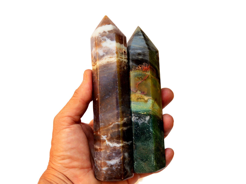 Two large ocean jasper obelisk crystals 130mm-140mm on hand with white background