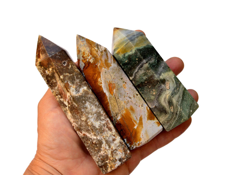 Three ocean jasper towers 100mm-120mm on hand with white background