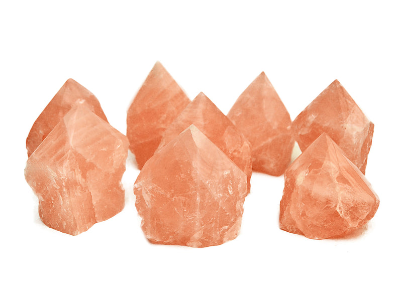 Some semi polished rose quartz points 55mm-90mm on white background