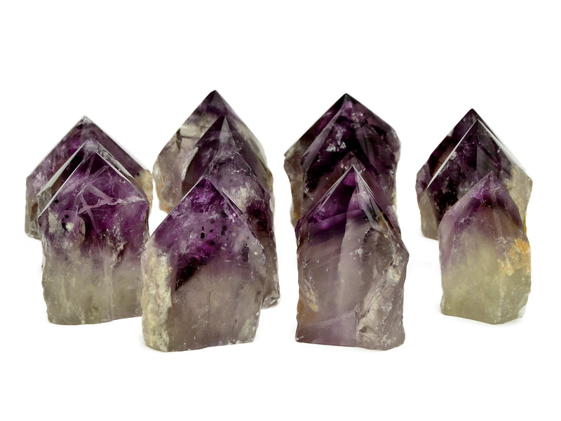 Ten amethyst semi polished points 65mm-90mm on white background