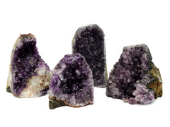 Four large druzy amethyst crystals cut base 98mm-122mm on white background