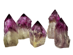 Five amethyst semi polished points 65mm-90mm on white background