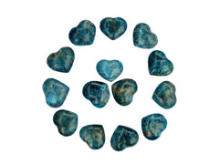 Several small blue apatite crystal hearts 30mm forming a circle on white background