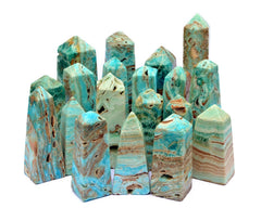Several blue aragonite crbackgroundystal obelisks different sizes on white background