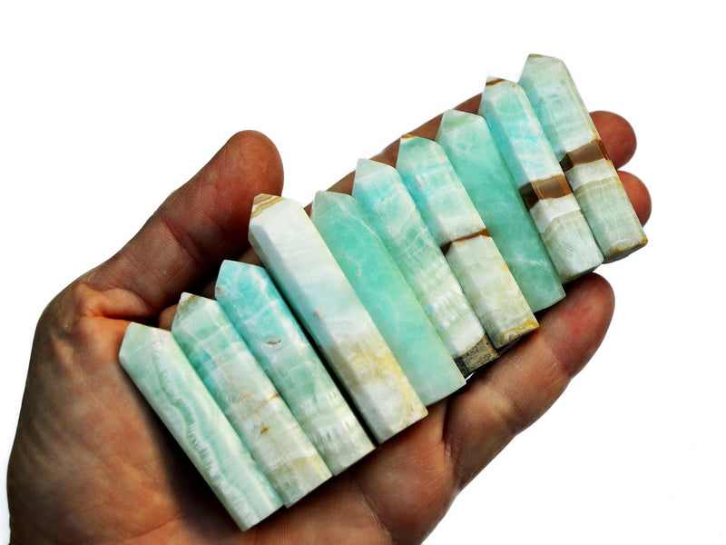Ten blue caribbean calcite crystal points 45mm-60mm on hand with white background
