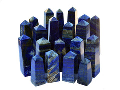Several blue lapis lazuli crystal towers 60mm-140mm on white background
