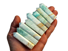 Eight blue caribbean calcite points 55mm-65mm on hand with white background
